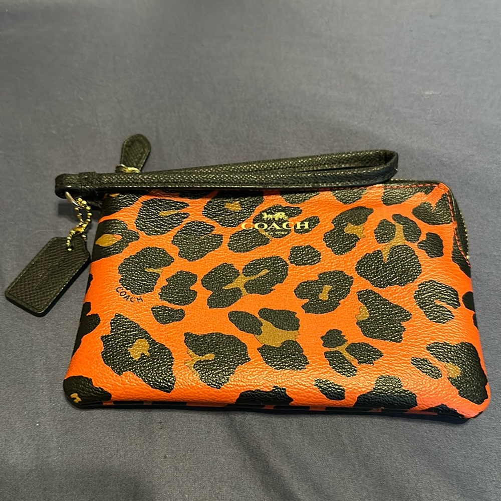 EC Coach wristlet. Burnt orange with black and tan leopard print
